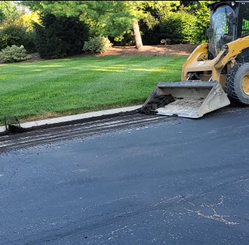 Cleaning Up Asphalt Millings Along Road Edge