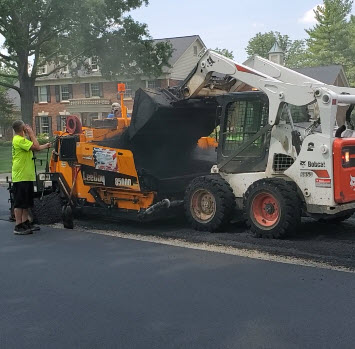 Dumping asphalt into paver