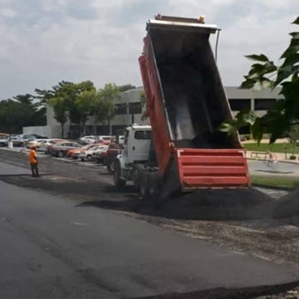 Double Axel Dump Truck Dumping 15 Tons of Hot Asphalt